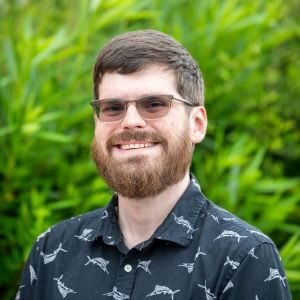 Boris, a white man with dark cropped hair and beard wearing glasses.